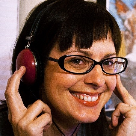 A woman listening to music with her headphones.