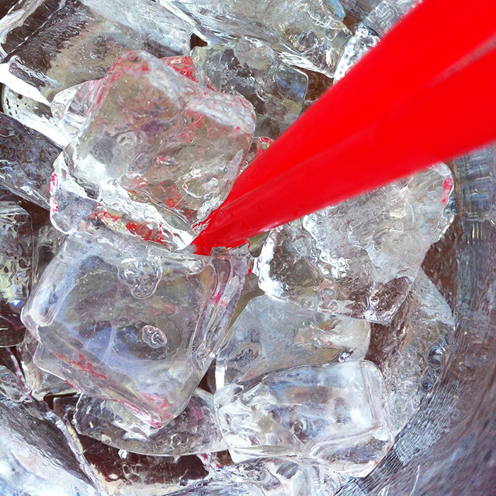Ice and straw in a glass