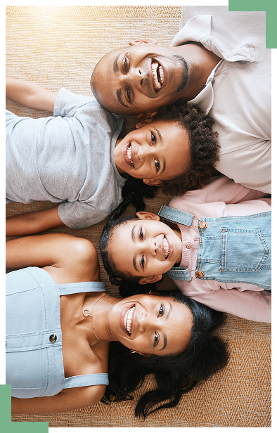 Family Dentistry Garden City KS Randall K McVey Happy family of four smiling together representing family dental care at Randall K. McVey, DMD PA in Garden City, KS