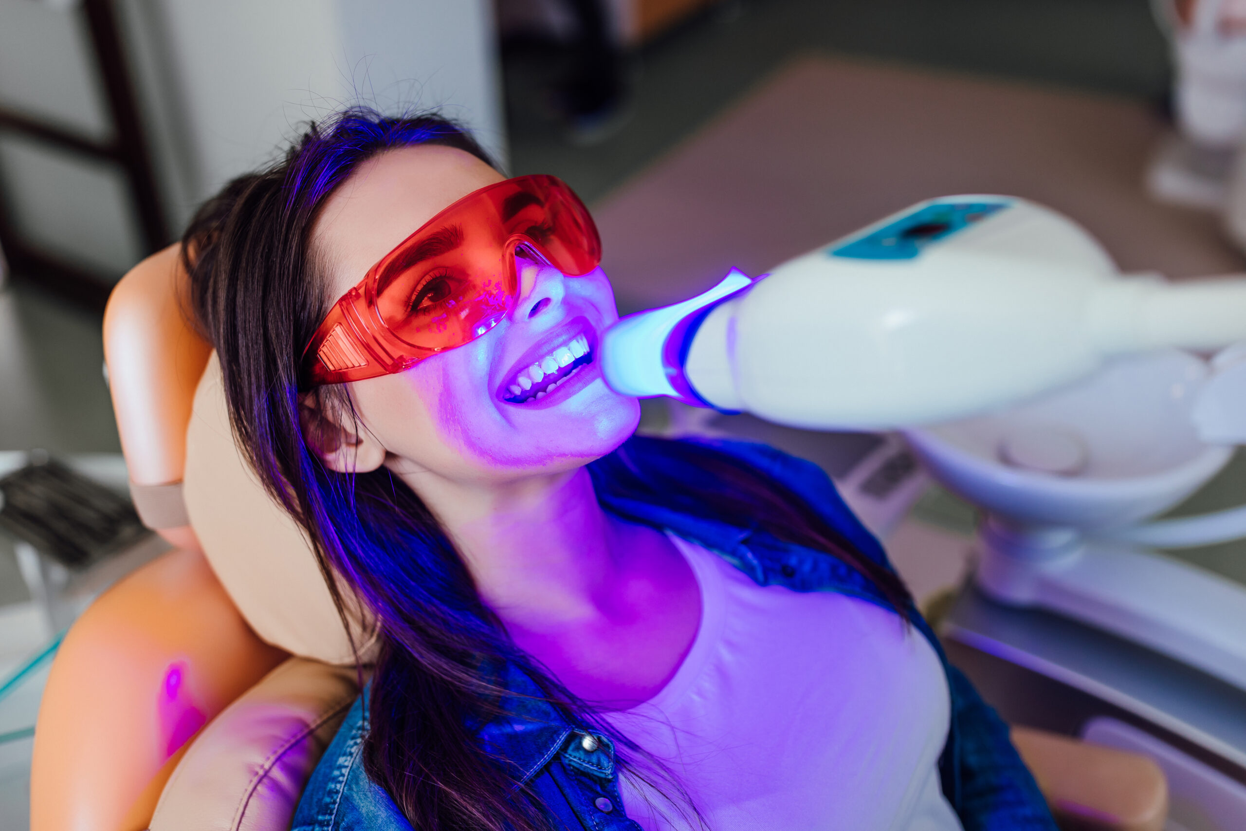 Teeth whitening for woman. Bleaching of the teeth at modern dent